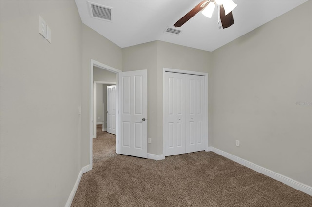 unfurnished bedroom featuring carpet floors, a closet, visible vents, and baseboards