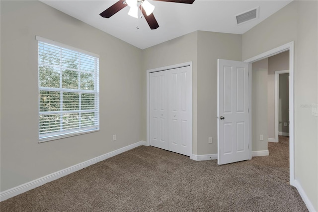 unfurnished bedroom featuring carpet floors, baseboards, and visible vents