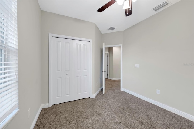 unfurnished bedroom featuring carpet, visible vents, and baseboards