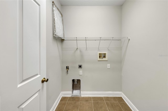 laundry room with washer hookup, hookup for an electric dryer, dark tile patterned flooring, laundry area, and baseboards