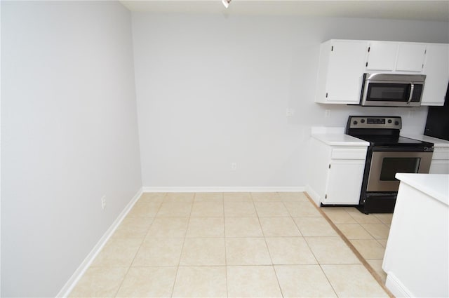 10263 Gandy Blvd N Unit 105, Saint Petersburg, FL 33702 - kitchen featuring stainless steel appliances, light countertops, white cabinetry, and light tile patterned floors