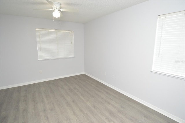 10263 Gandy Blvd N Unit 105, Saint Petersburg, FL 33702 - spare room featuring wood finished floors, ceiling fan, baseboards, and a textured ceiling