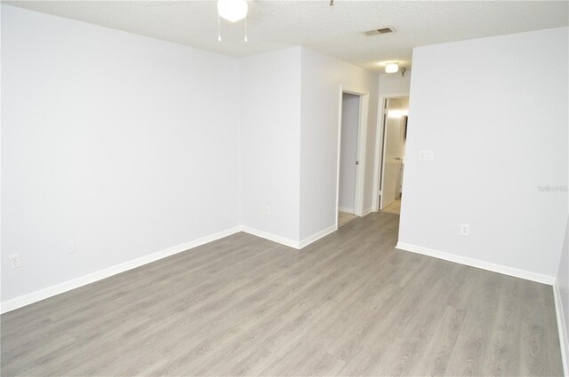 10263 Gandy Blvd N Unit 105, Saint Petersburg, FL 33702 - unfurnished room featuring wood finished floors, a ceiling fan, baseboards, and a textured ceiling