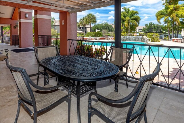 10263 Gandy Blvd N Unit 105, Saint Petersburg, FL 33702 - balcony with view of pool area, a patio area, and outdoor dining space