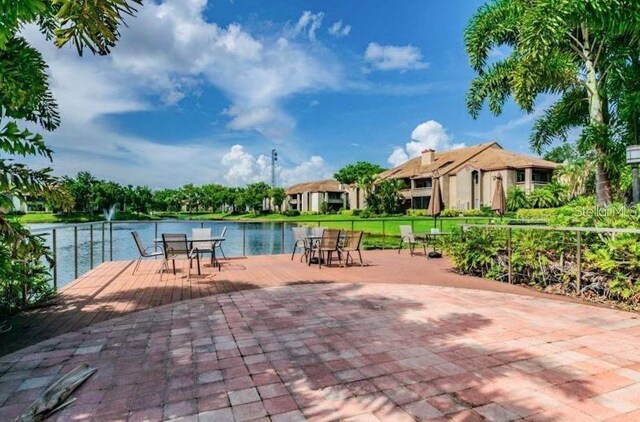 10263 Gandy Blvd N Unit 105, Saint Petersburg, FL 33702 - view of swimming pool with a water view and outdoor dining space