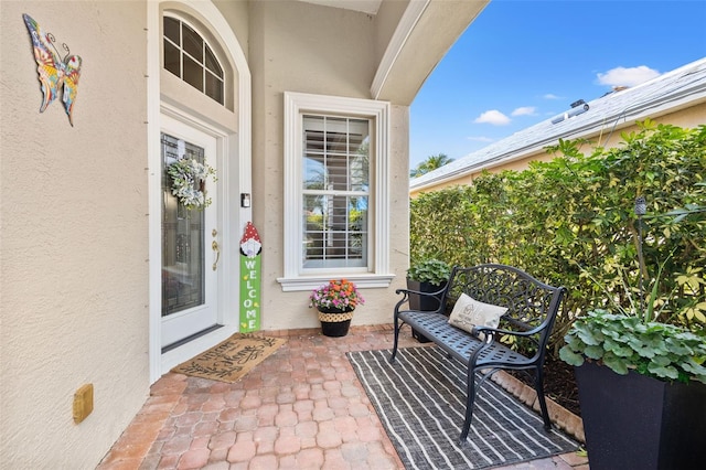 doorway to property with a patio area and stucco siding