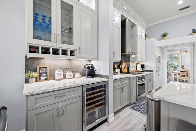 bar featuring wine cooler, crown molding, visible vents, appliances with stainless steel finishes, and wall chimney exhaust hood