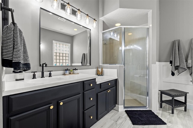 full bath with a shower stall and vanity