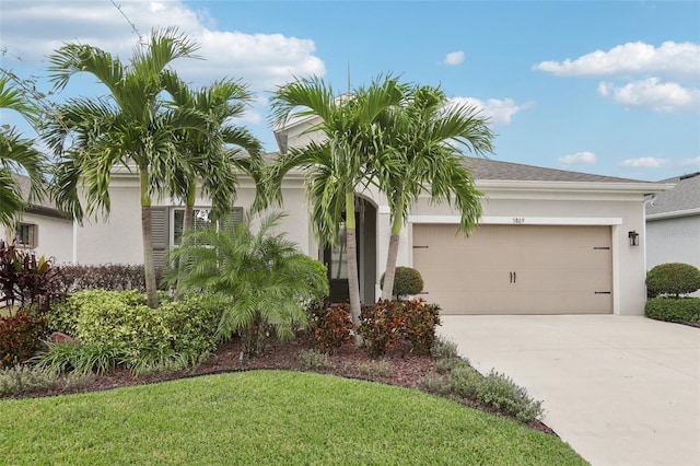 view of front of property with a front lawn and a garage