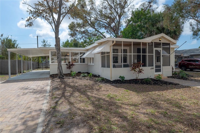 manufactured / mobile home featuring a sunroom and a carport