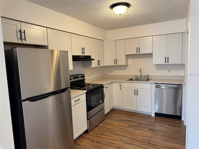 kitchen with dark wood-type flooring, sink, a textured ceiling, appliances with stainless steel finishes, and white cabinets