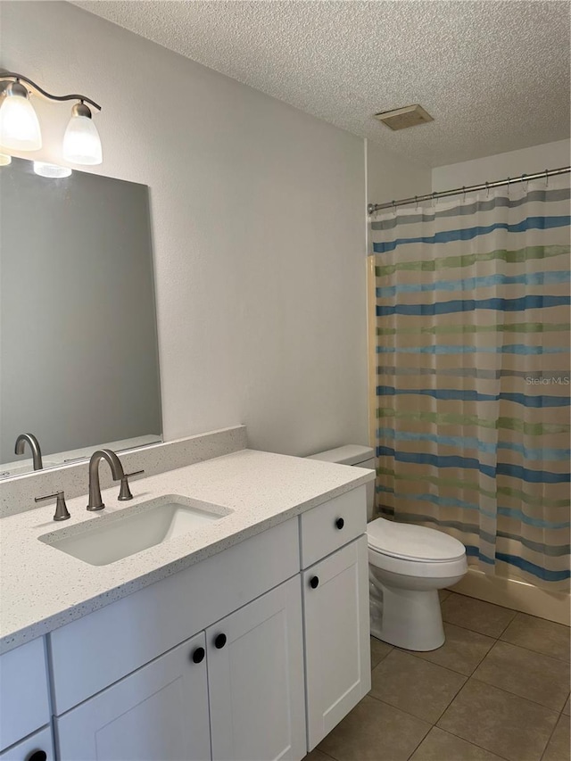 full bathroom featuring a textured ceiling, vanity, toilet, shower / bathtub combination with curtain, and tile patterned floors