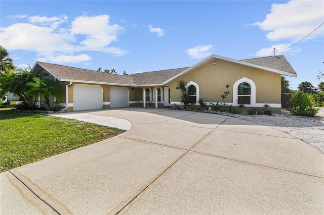 ranch-style home featuring a garage and a front yard