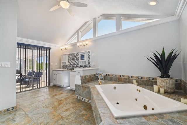 bathroom with tiled tub, ceiling fan, tasteful backsplash, vanity, and a textured ceiling