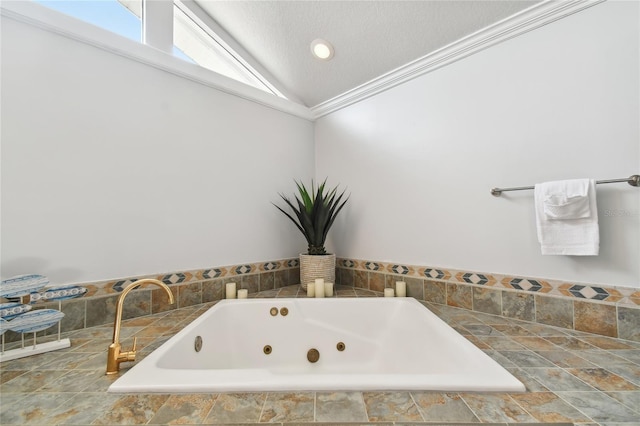 bathroom featuring crown molding, lofted ceiling, a textured ceiling, and tiled tub