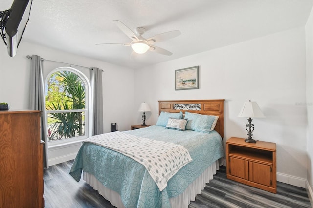 bedroom with dark hardwood / wood-style floors and ceiling fan