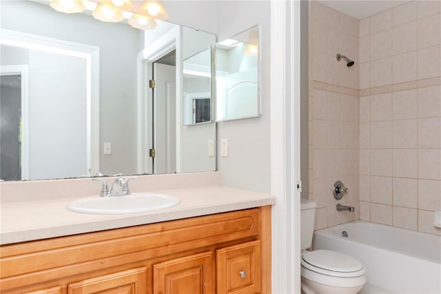 full bathroom featuring vanity, toilet, and tiled shower / bath combo