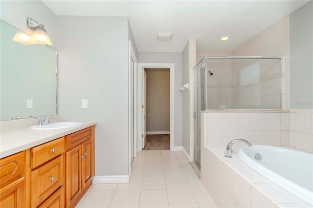 bathroom featuring independent shower and bath, vanity, and tile patterned floors