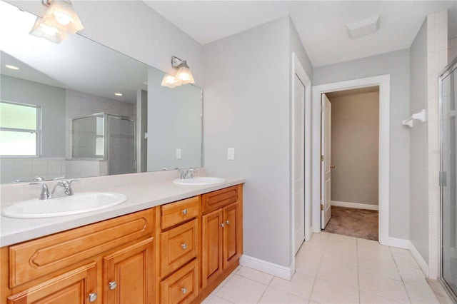 bathroom featuring vanity, an enclosed shower, and tile patterned floors