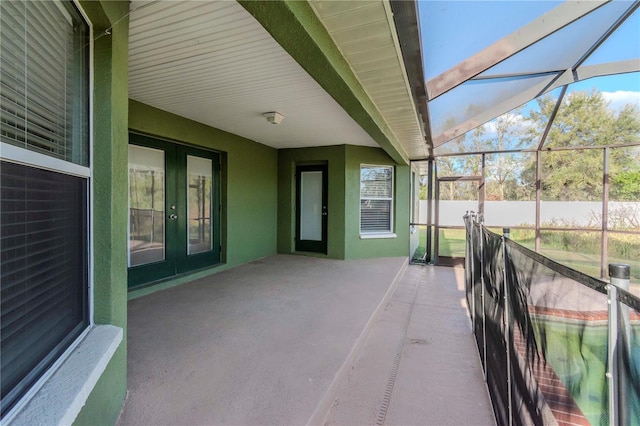 view of patio featuring a lanai and french doors