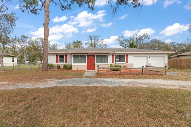 ranch-style house with a garage and a front lawn