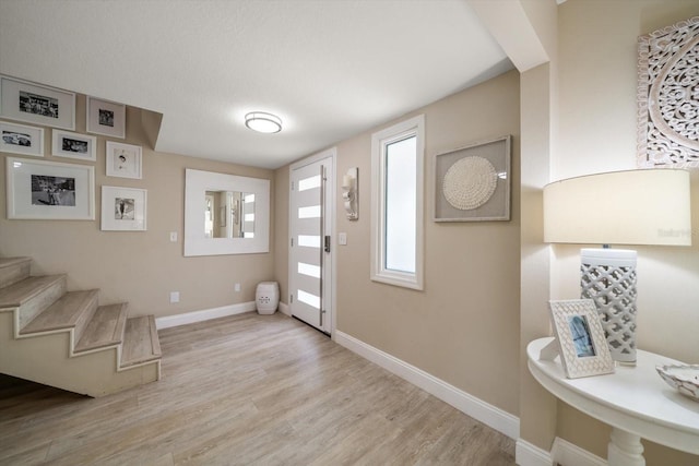 foyer entrance with light wood-type flooring