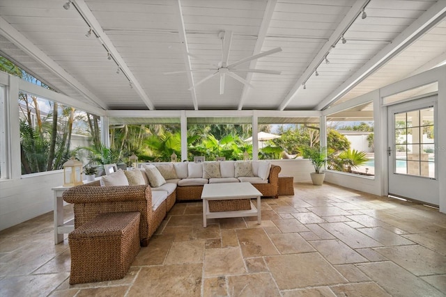 sunroom / solarium with ceiling fan, track lighting, vaulted ceiling, and a wealth of natural light