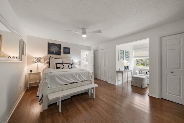 bedroom with dark wood-type flooring, ceiling fan, and a textured ceiling