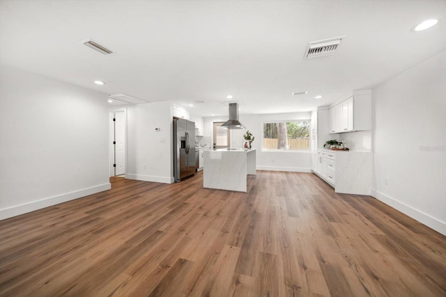 unfurnished living room featuring hardwood / wood-style floors