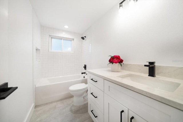 full bathroom featuring vanity, tiled shower / bath, tile patterned flooring, and toilet