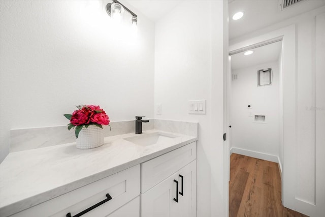 bathroom with vanity and wood-type flooring