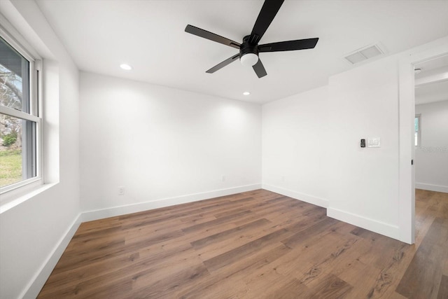 spare room featuring dark wood-type flooring and ceiling fan