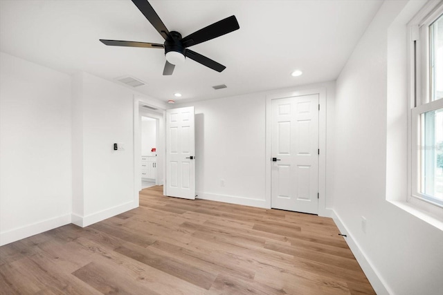 unfurnished room with ceiling fan and light wood-type flooring