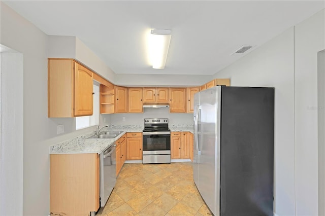 kitchen featuring a sink, appliances with stainless steel finishes, light brown cabinets, and visible vents