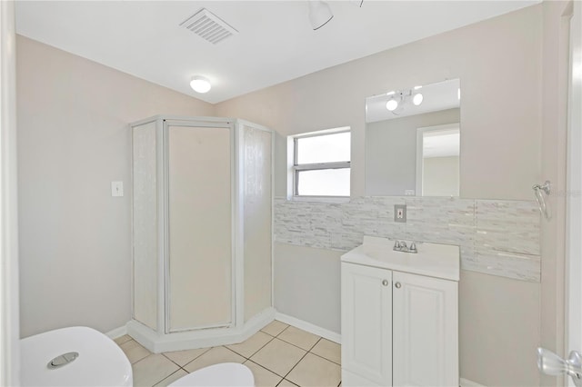 full bath featuring vanity, toilet, tile patterned floors, visible vents, and a stall shower