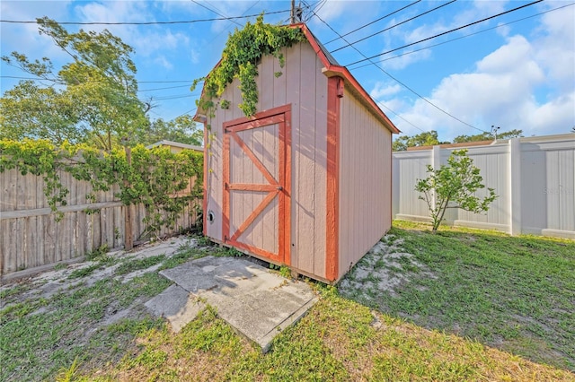 view of shed with a fenced backyard