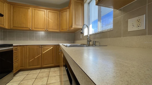 kitchen with electric stove, backsplash, sink, and light tile patterned floors