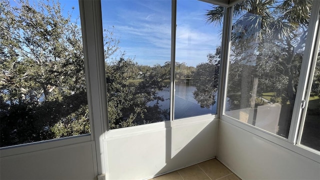 unfurnished sunroom featuring a water view