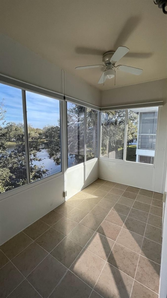 unfurnished sunroom featuring ceiling fan