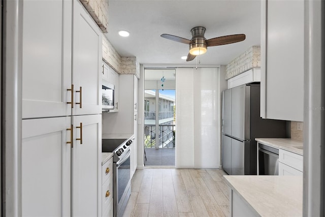 kitchen featuring white cabinets, stainless steel appliances, and light countertops