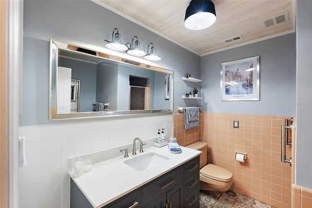 bathroom with wainscoting, visible vents, a shower stall, and toilet