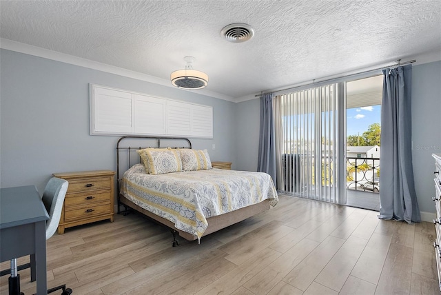 bedroom with light wood finished floors, access to exterior, visible vents, and a wall of windows