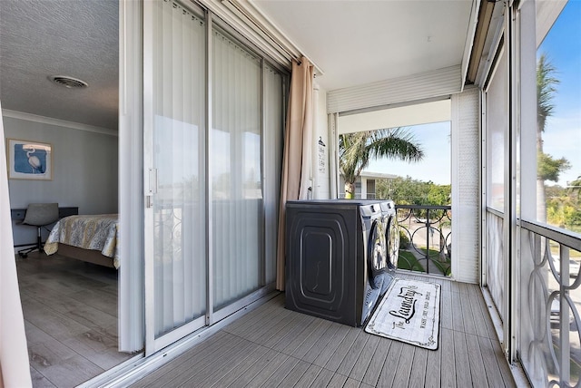 balcony with washing machine and dryer and visible vents