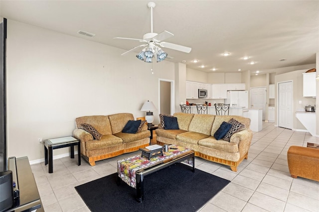 living room featuring visible vents, ceiling fan, baseboards, and light tile patterned floors