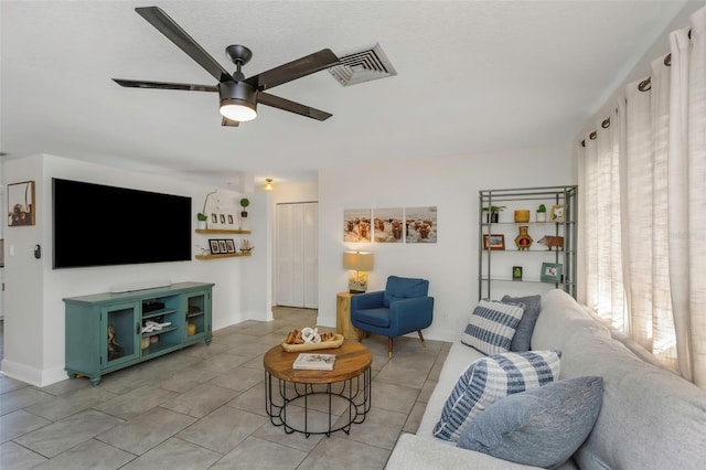 living room featuring light tile patterned floors and ceiling fan