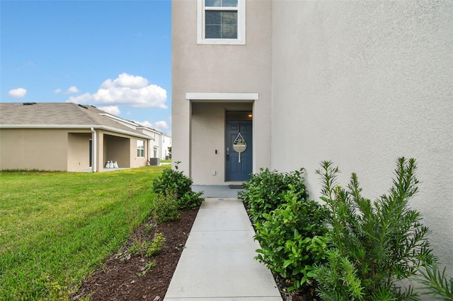 16126 Sunday Stroll Way, Odessa, FL 33556 - doorway to property with stucco siding, a yard, and central air condition unit