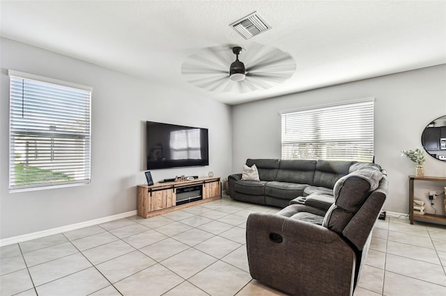 16126 Sunday Stroll Way, Odessa, FL 33556 - living room featuring light tile patterned floors, healthy amount of natural light, baseboards, and ceiling fan