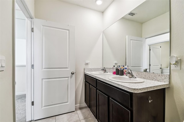 16126 Sunday Stroll Way, Odessa, FL 33556 - bathroom featuring double vanity, tile patterned flooring, and baseboards