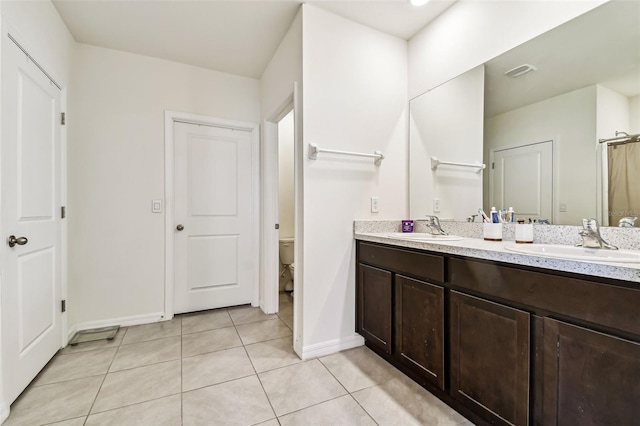 16126 Sunday Stroll Way, Odessa, FL 33556 - full bath featuring baseboards, tile patterned floors, double vanity, and toilet
