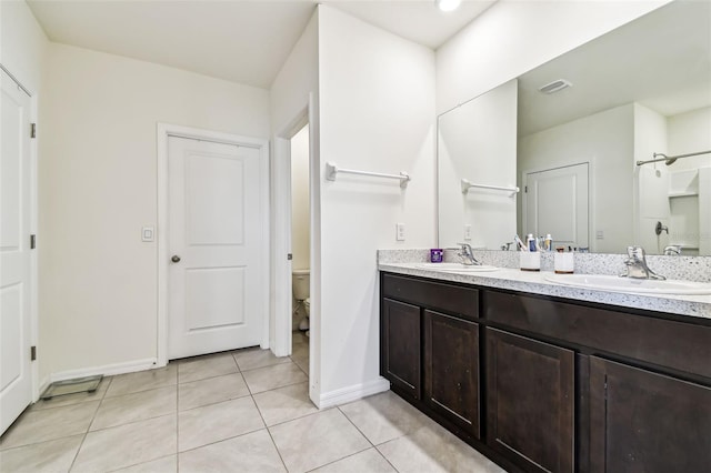 16126 Sunday Stroll Way, Odessa, FL 33556 - bathroom featuring tile patterned floors, baseboards, double vanity, and toilet